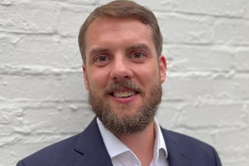 A photo of Terry Whittle in a blue suit, smiling
